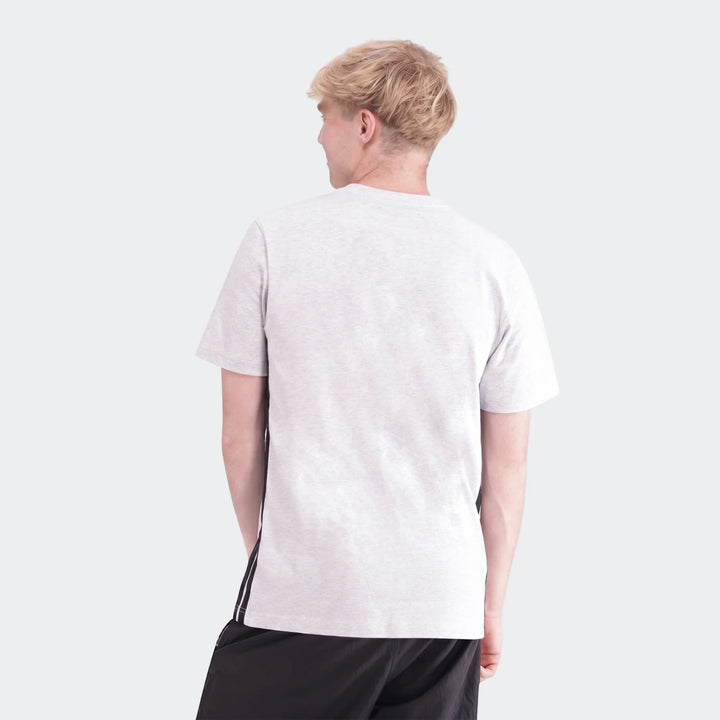 Male model wearing a light grey melange 3-Stripes Single Jersey T-Shirt and black shorts, captured from the back.