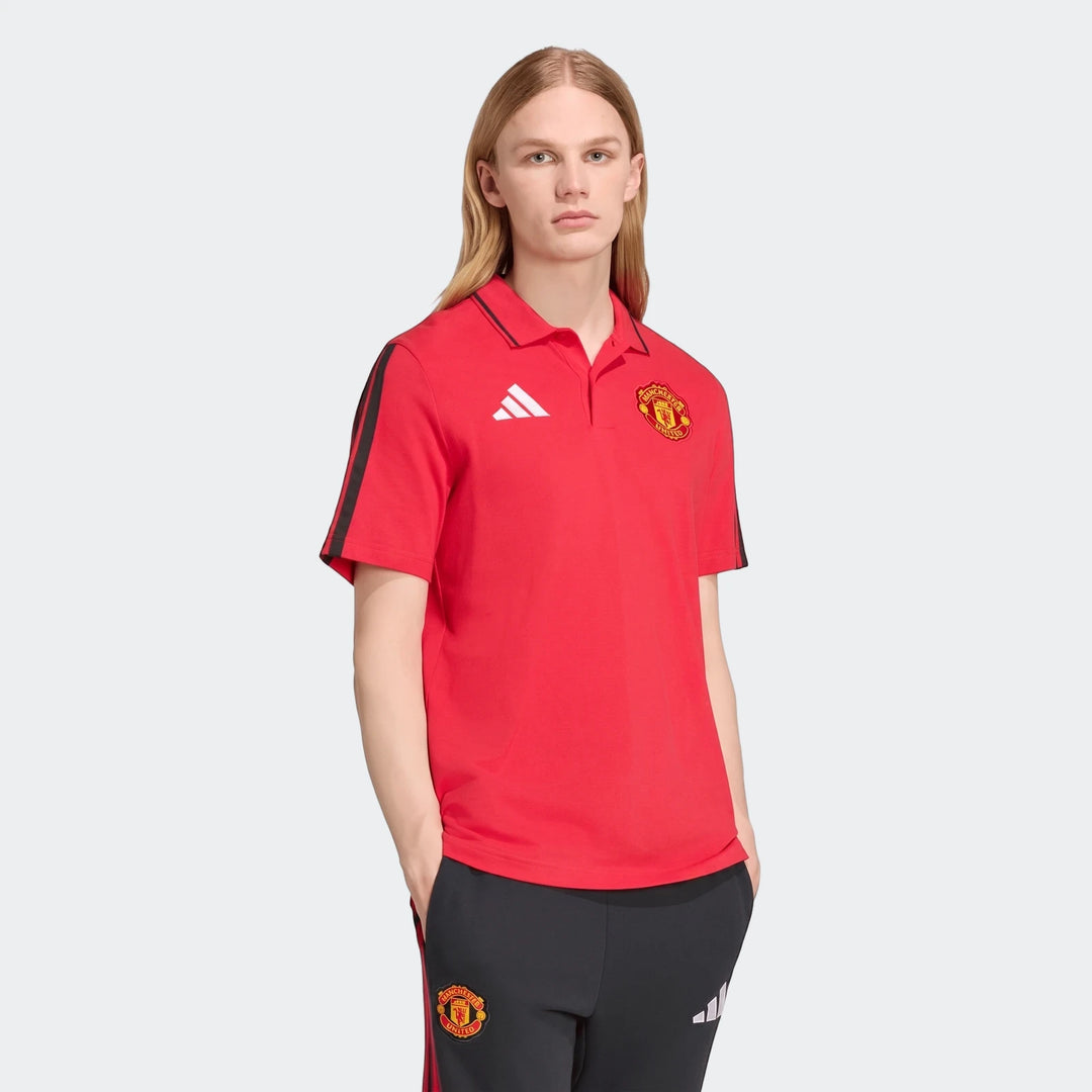 Male model wearing a red Adidas Manchester United DNA polo shirt with black stripes on sleeves and matching black