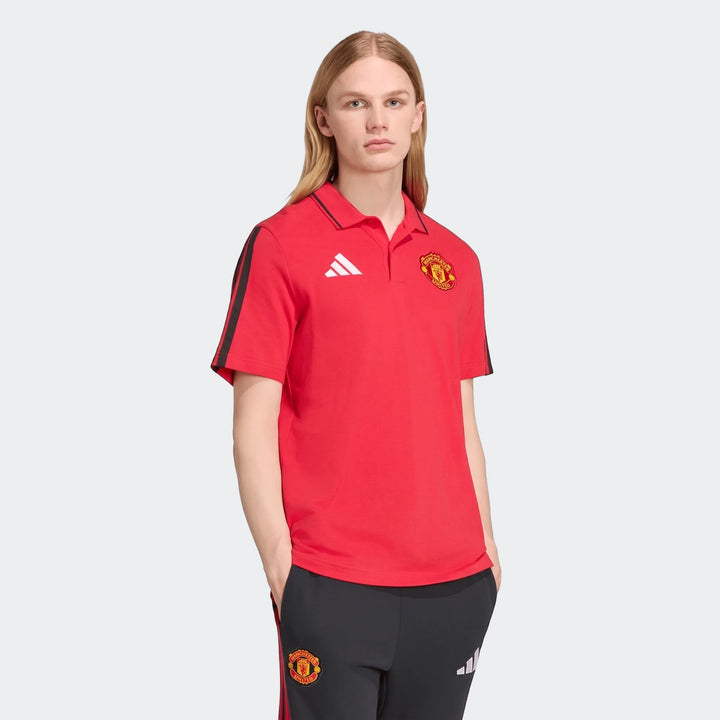 Male model wearing a red Adidas Manchester United DNA polo shirt with black stripes on sleeves and matching black