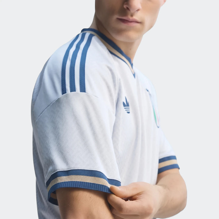 Close-up of a male model wearing a light blue Z.N.E. Track Top with white and blue stripes, showcasing the textured fabric
