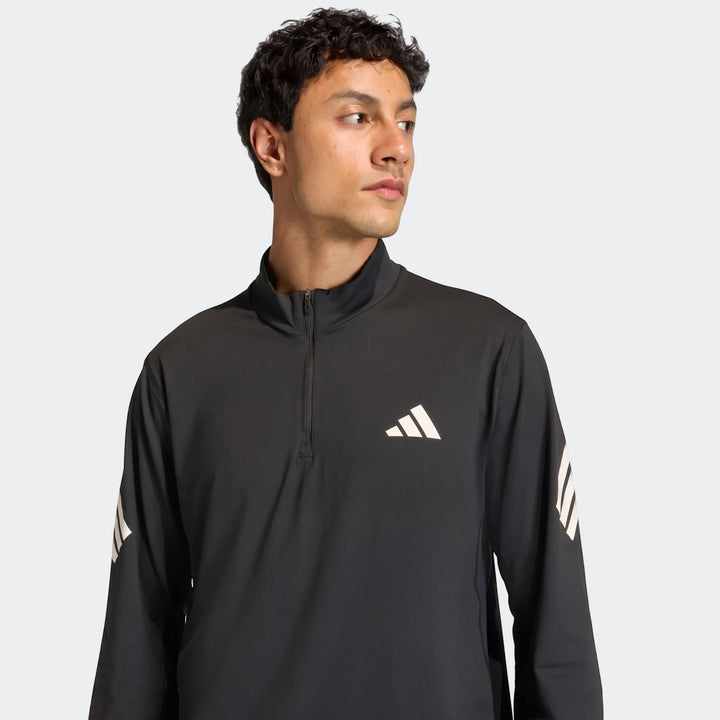 Front view of a man wearing a black Adidas Adi365 Full-Zip Sweatshirt with white logo and sleeve stripes.