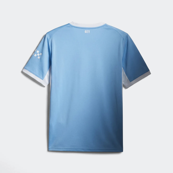 Back view of a light blue Manchester City 26/27 Home Jersey for men, featuring white trim, a V-neck, and a checkered sleeve