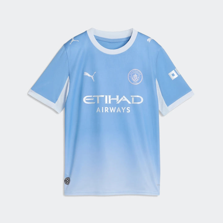 Manchester City 26/27 Home Jersey for youth, light blue with white trim, featuring team crest and sponsor logo on the front.