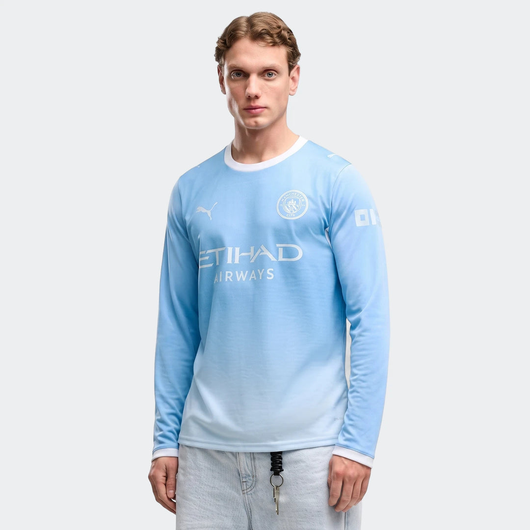 Men's Manchester City 26/27 Home Long Sleeve Jersey in light blue, modeled by a man in light wash jeans.