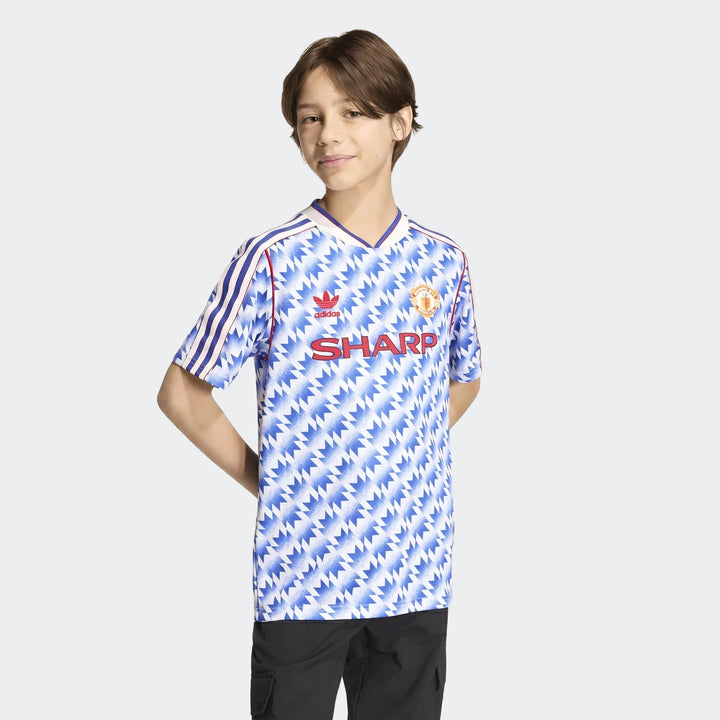 Manchester United 1990 Away Jersey Kids in blue and white zigzag print, short sleeve football shirt, front view.