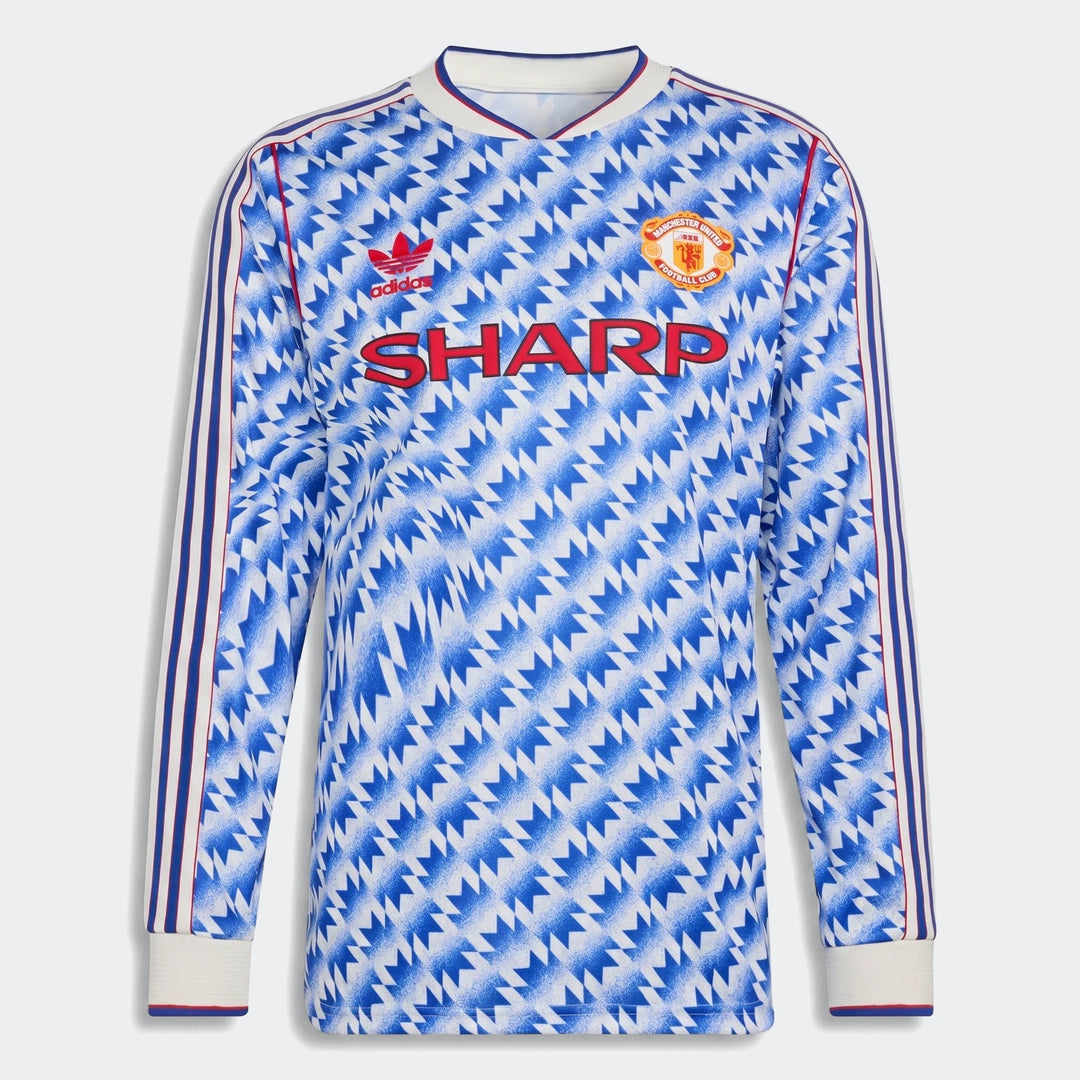 Manchester United 1990 long sleeve away jersey, front view in blue and white geometric pattern with club crest.
