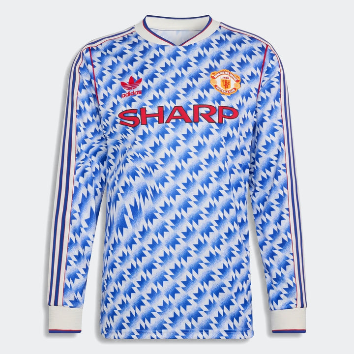 Manchester United 1990 long sleeve away jersey, front view in blue and white geometric pattern with club crest.