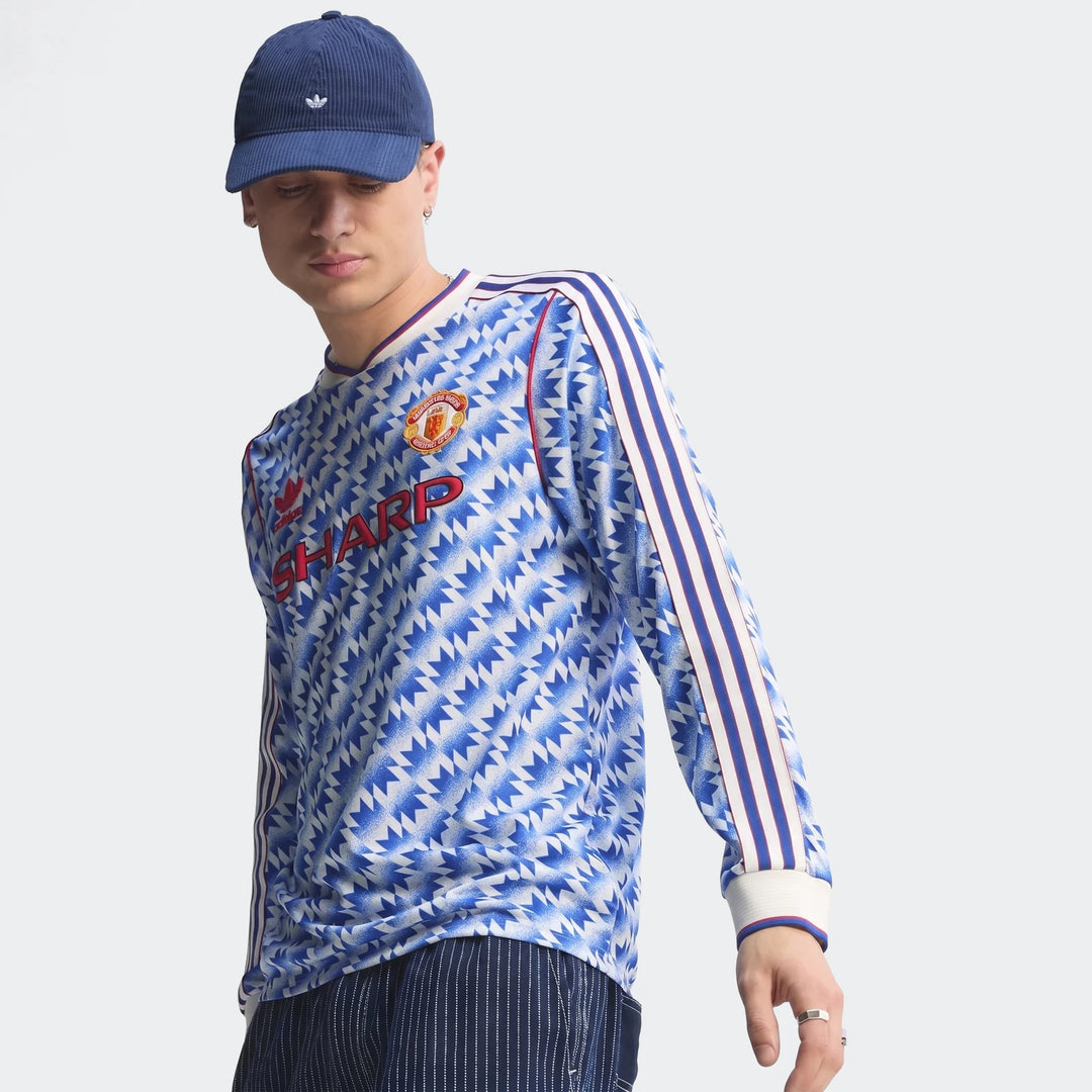 Manchester United 1990 long sleeve away jersey in blue and white geometric print, front view with club crest
