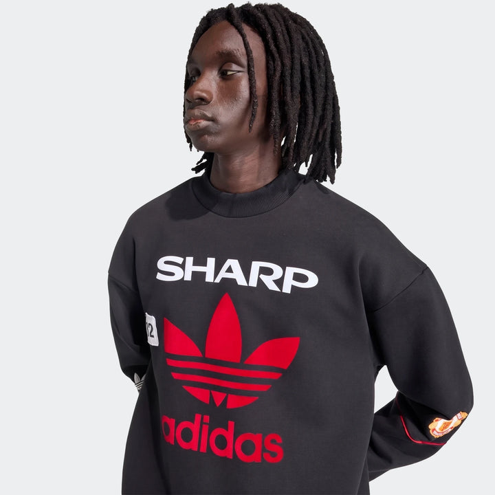 Manchester United 1990 Sweatshirt in black, crewneck pullover with red adidas trefoil and Sharp logo, front view.
