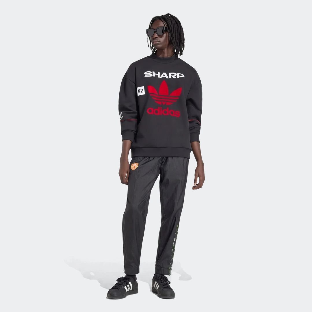 Manchester United 1990 Sweatshirt in black, crewneck pullover with red adidas trefoil and Sharp print, front view.