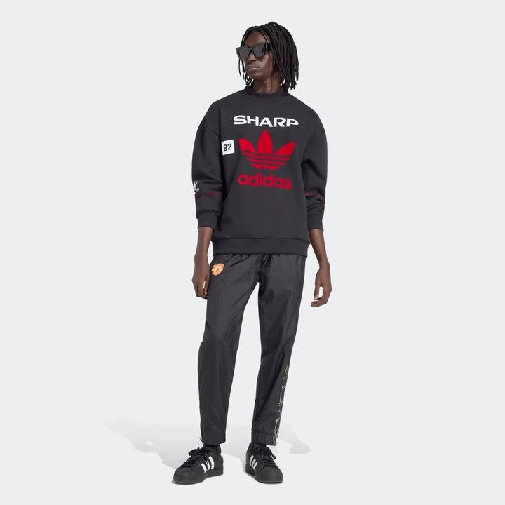 Manchester United 1990 Sweatshirt in black, crewneck pullover with red adidas trefoil and Sharp print, front view.