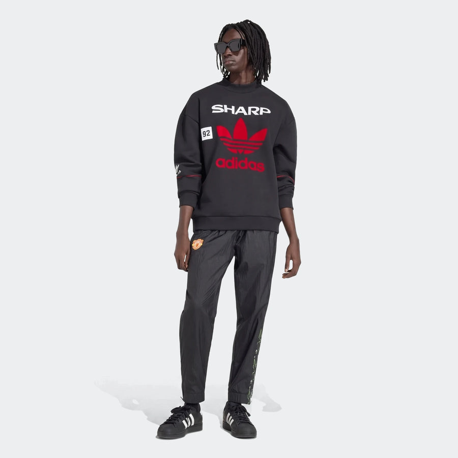 Manchester United 1990 Sweatshirt in black, crewneck pullover with red adidas trefoil and Sharp print, front view.