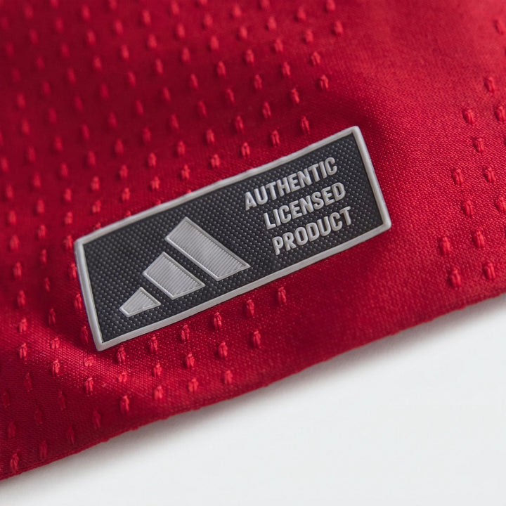 Manchester United 26/27 Authentic Long Sleeve Home Jersey close-up showing red textured fabric and authentic badge.