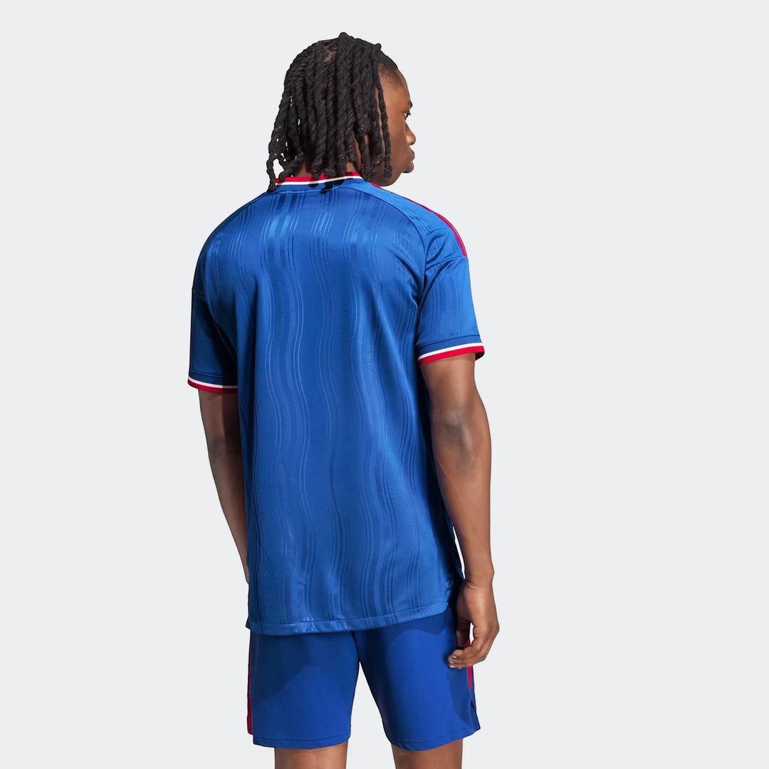 Back view of a person wearing a blue Manchester United 26/27 Away Jersey Authentic and matching blue shorts.