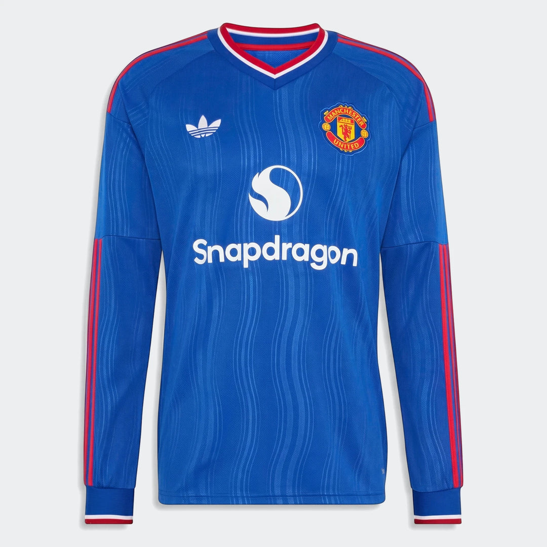 Blue Manchester United 26/27 away long-sleeve jersey with team crest and sponsor logo on a white background.