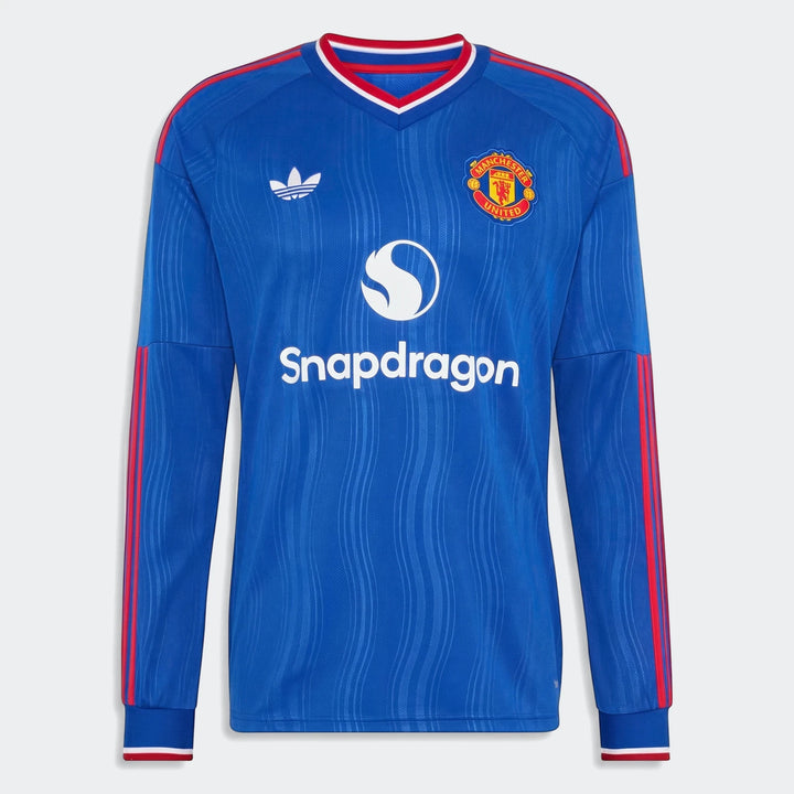 Blue Manchester United 26/27 away long-sleeve jersey with team crest and sponsor logo on a white background.