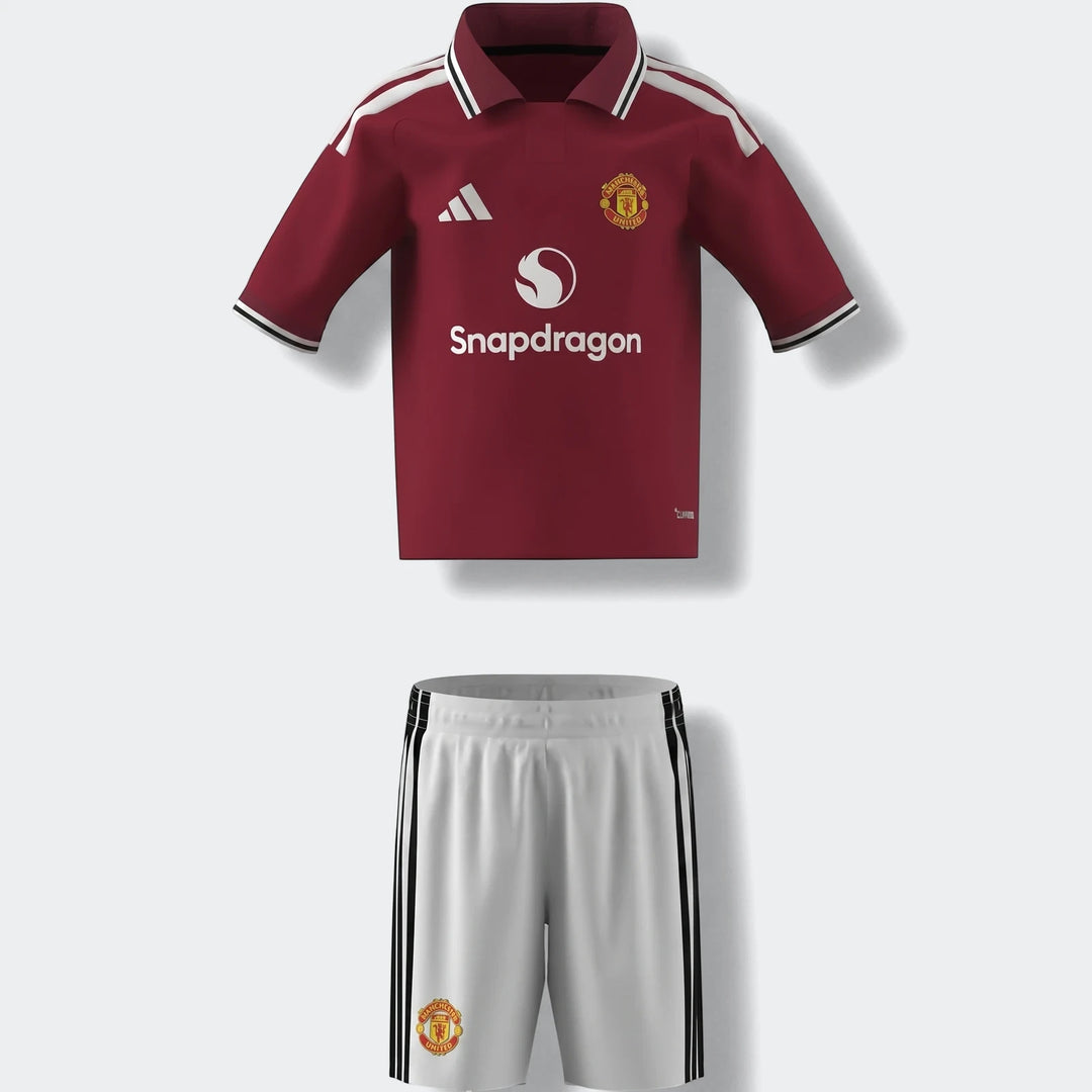 Manchester United 26/27 Home Mini Kit featuring a maroon jersey with white accents and white shorts with black stripes,