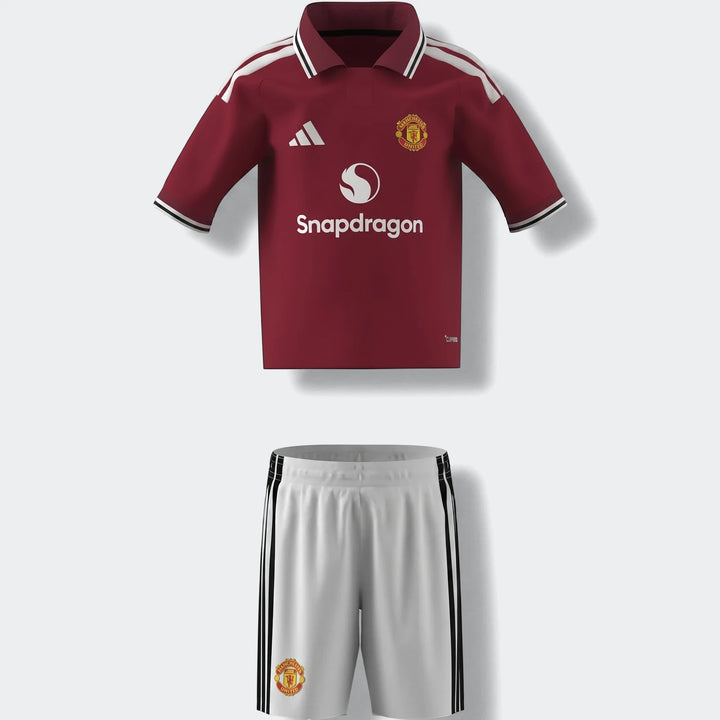 Manchester United 26/27 Home Mini Kit featuring a maroon jersey with white accents and white shorts with black stripes,