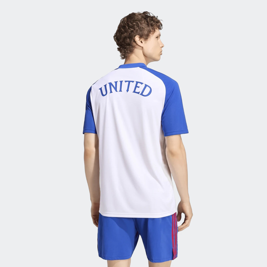 Male model from the back wearing the white and blue Manchester United 26/27 Pre Match Jersey and blue shorts.
