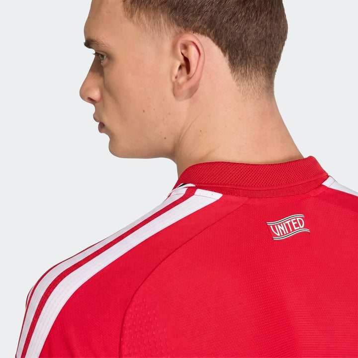 Manchester United 26/27 Authentic Home Jersey in red, back view showing white shoulder stripes and United badge.