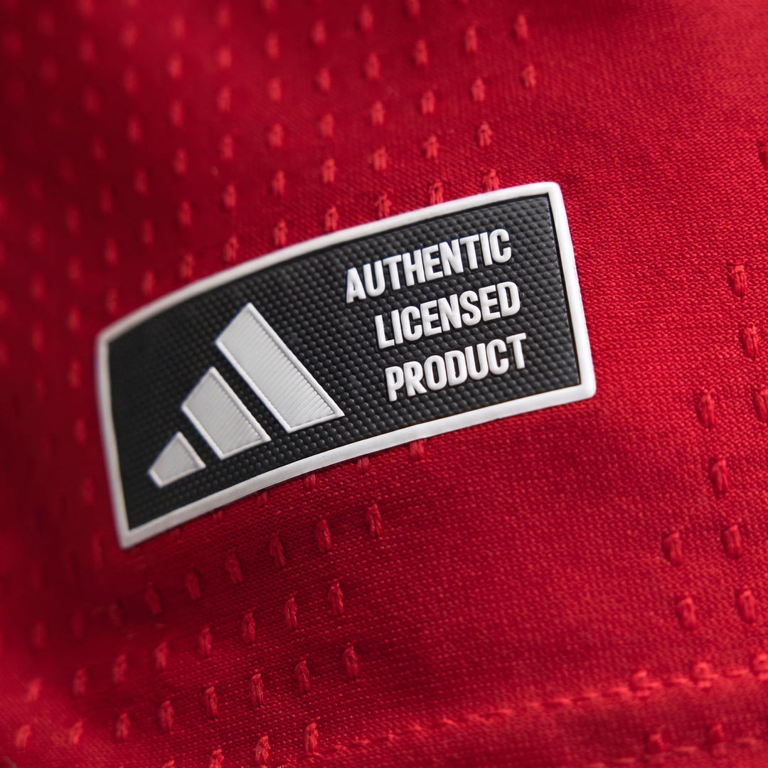 Manchester United 26/27 Authentic Home Jersey in red, close-up of textured fabric with Authentic Licensed Product badge