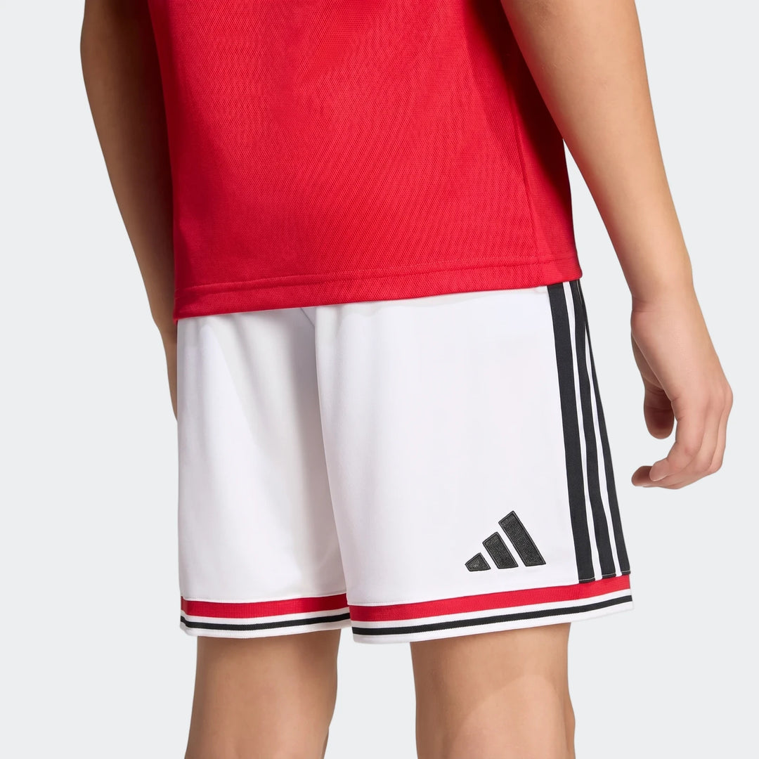 Manchester United 26/27 Home Shorts Youth in white with black side stripes and red hem trim, side view.
