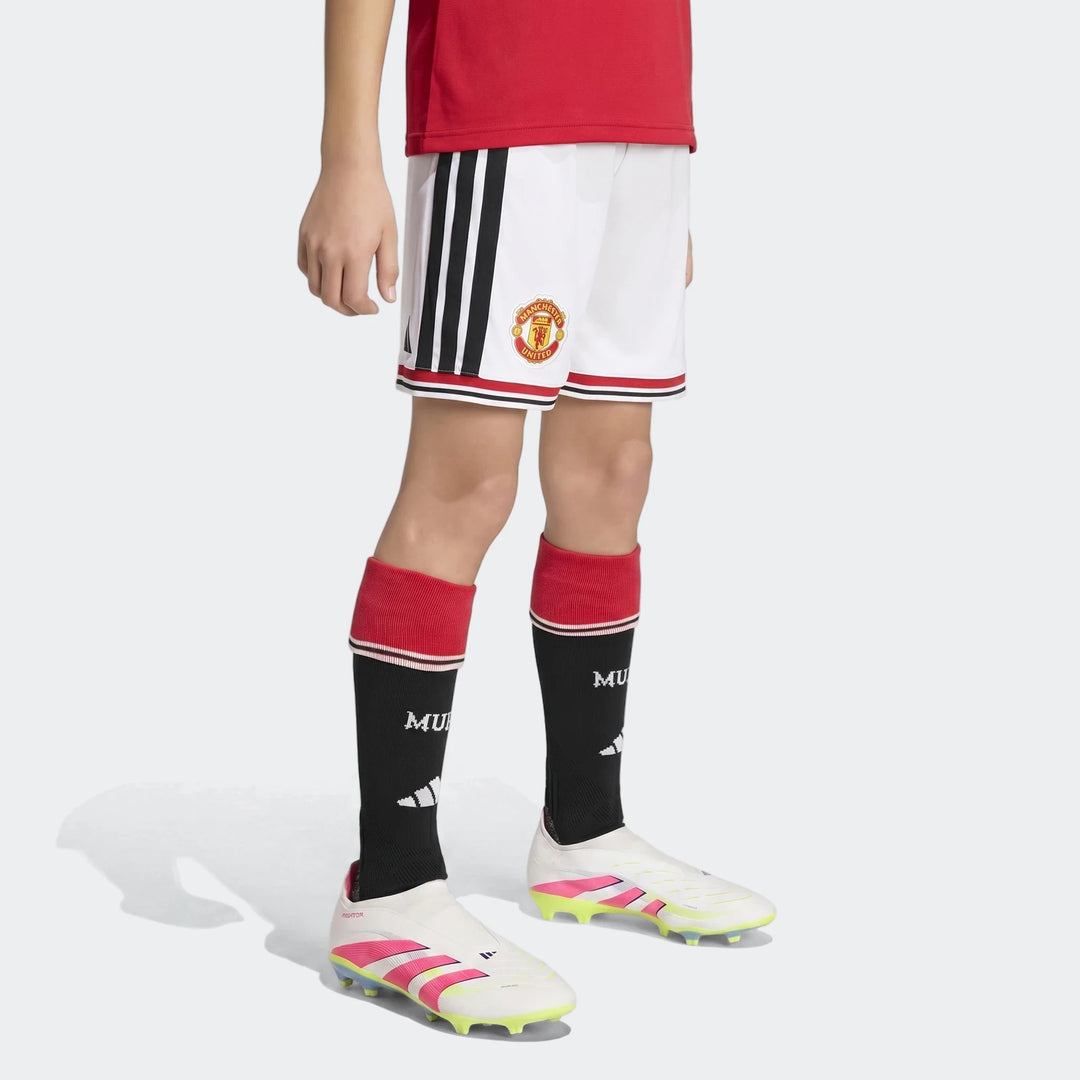 Manchester United 26/27 Home Shorts Youth in white with black side stripes and club crest, front view.
