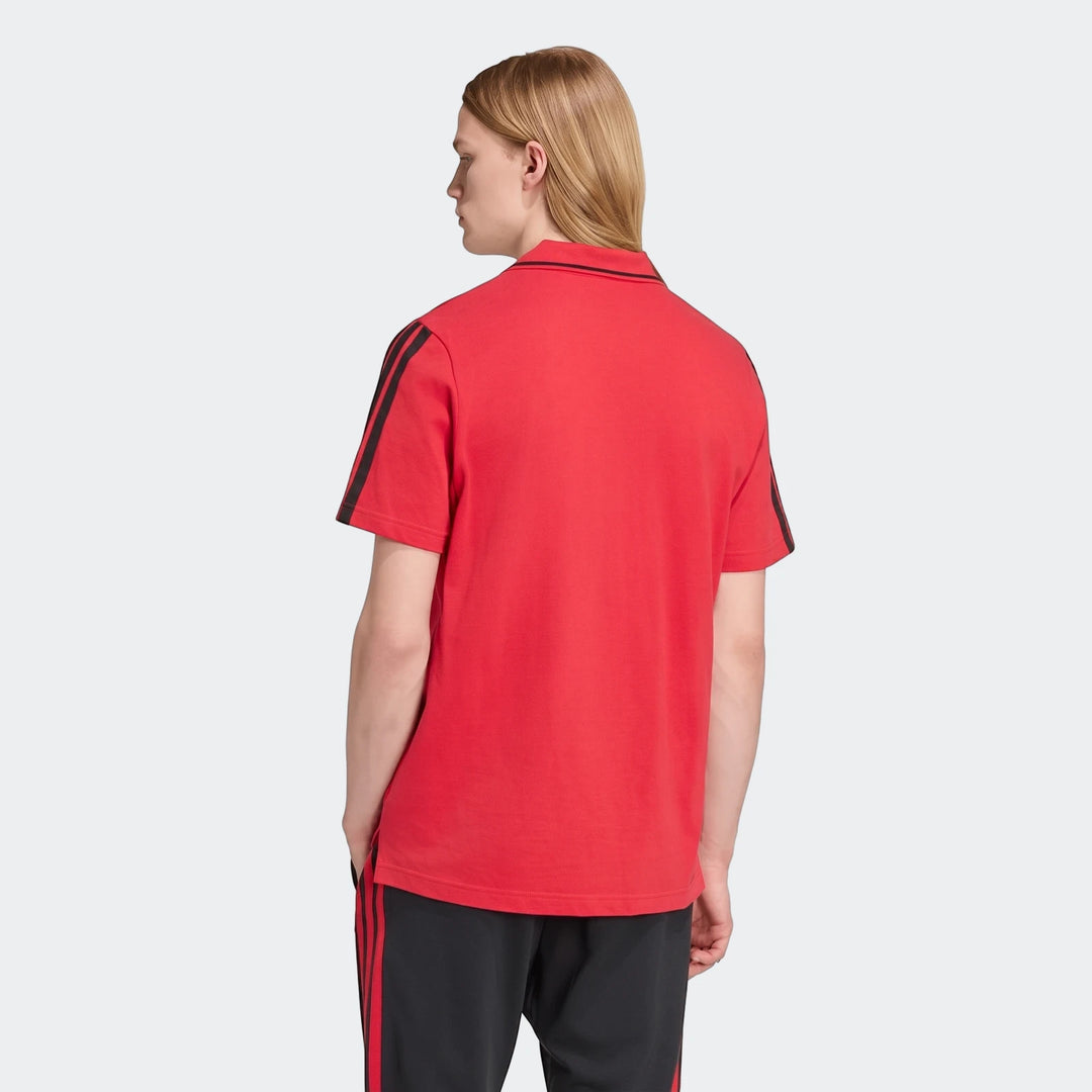 Men's red Manchester United Dna Polo Shirt with black stripes, worn by a male model, shown from the back.
