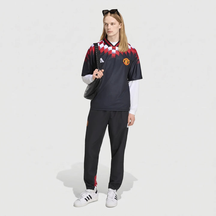Manchester United Street Jersey in black with red and white checkered shoulder pattern, front view.