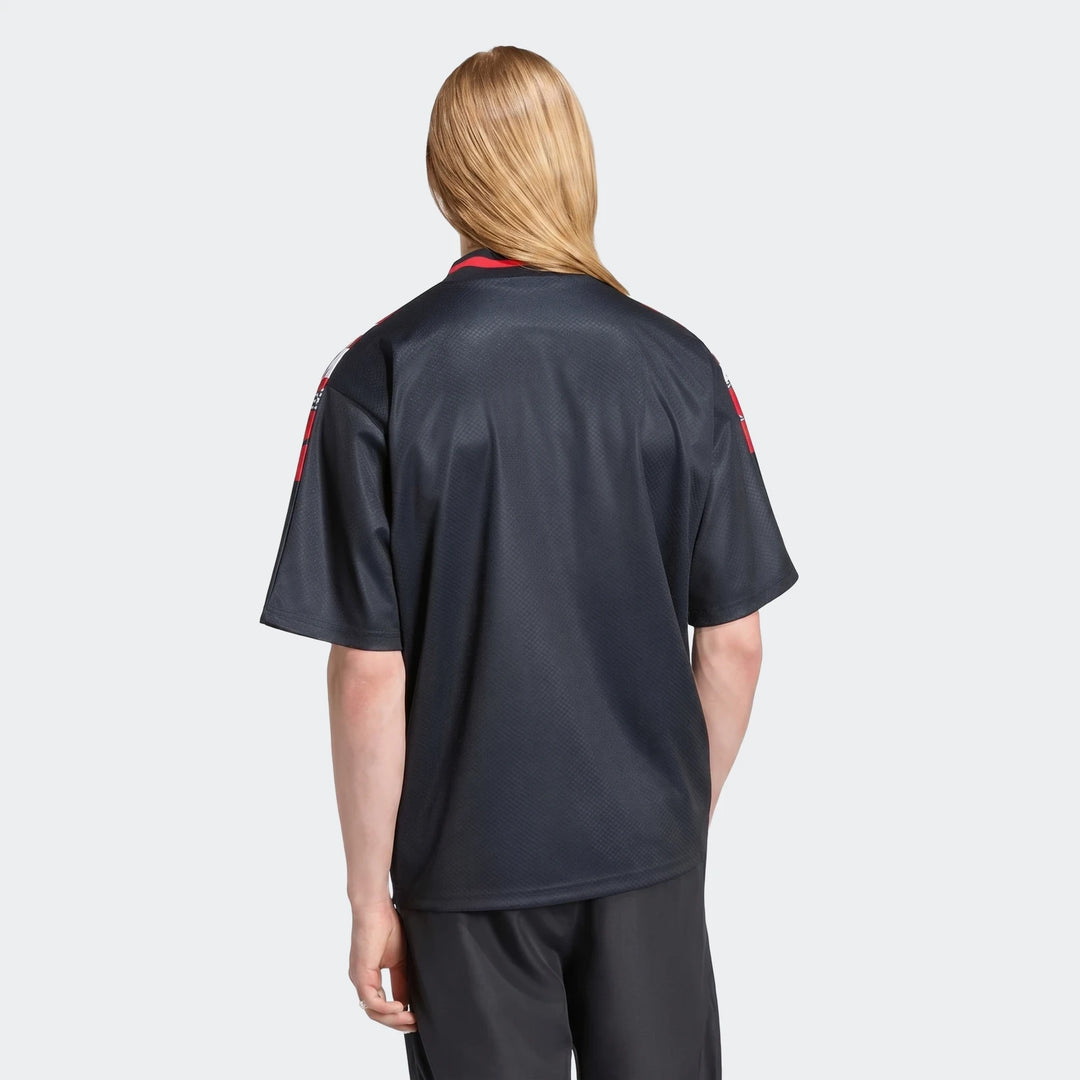 Back view of Manchester United Street Jersey in black with red shoulder accents and short sleeves.
