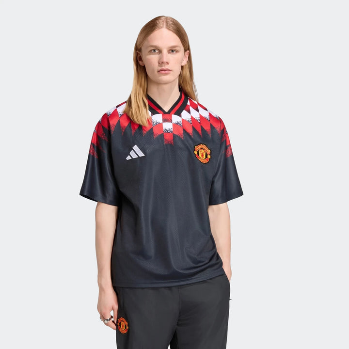 Manchester United Street Jersey in black with red and white geometric shoulder pattern, short sleeve front view
