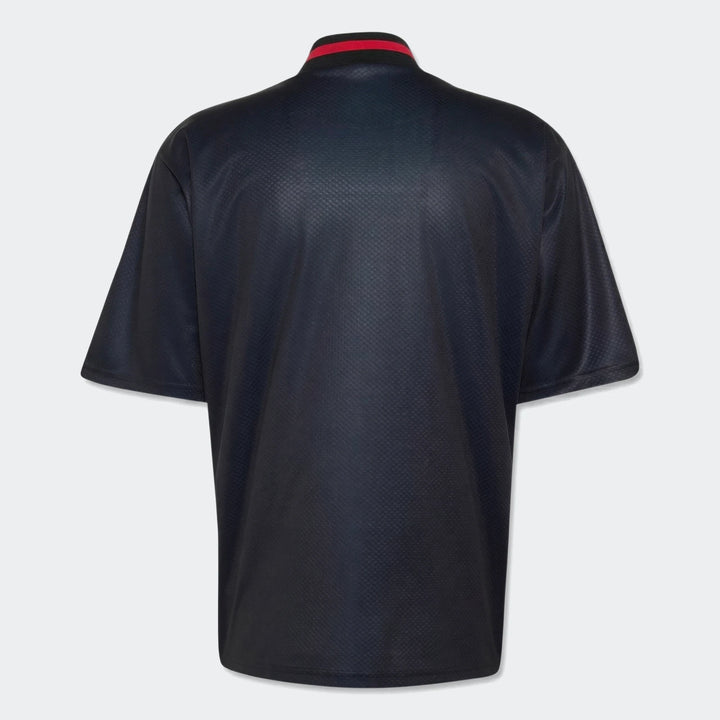 Manchester United Street Jersey in dark navy, back view, short-sleeve with red-striped ribbed collar.