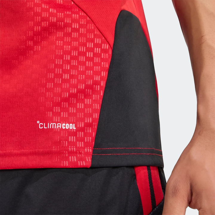 Close-up of a red and black Manchester United 26/27 Tiro Training Jersey featuring the white ClimaCool logo and striped