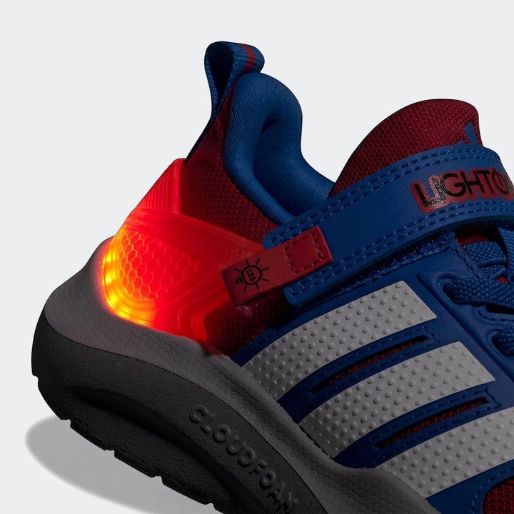 Close-up angled view of a blue and red Marvel Lightorama Runner Spider-Man kids' light-up shoe with a glowing red heel.