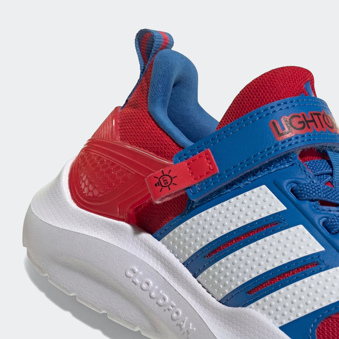 Close-up of Marvel Lightorama Runner Spider-Man Light-Up Kids Shoes in red, blue, and white with Adidas stripes.