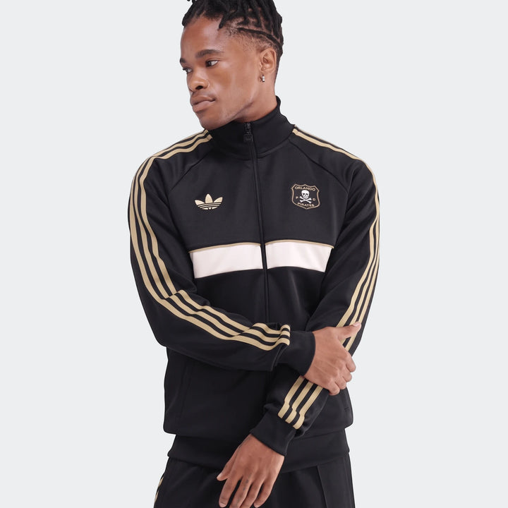 Men's black Adidas Orlando Pirates track jacket with gold stripes and white chest band, worn by a male model.