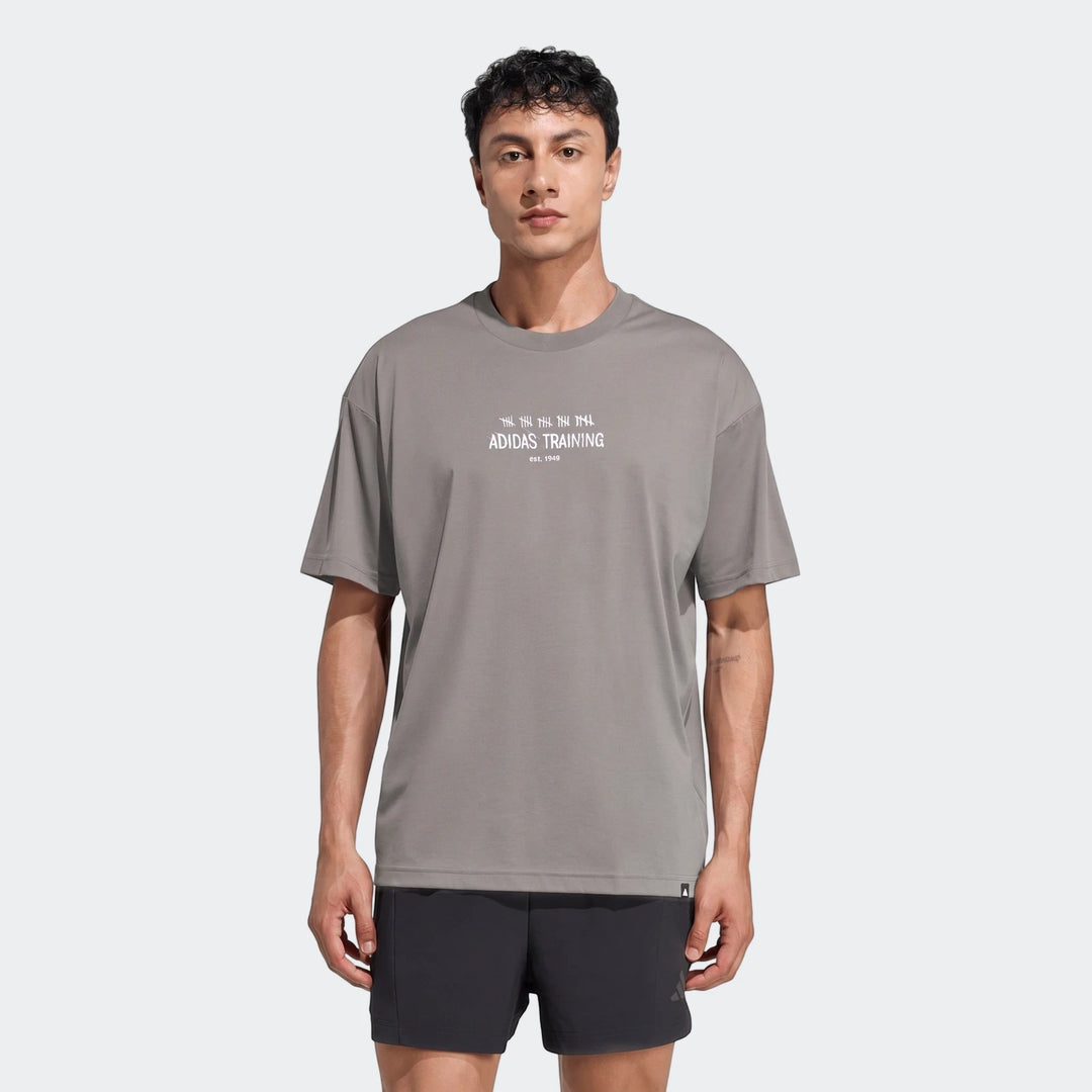 Men's Adidas Primelift Graphic T-Shirt in grey, featuring a crew neck and short sleeves, worn by a model.