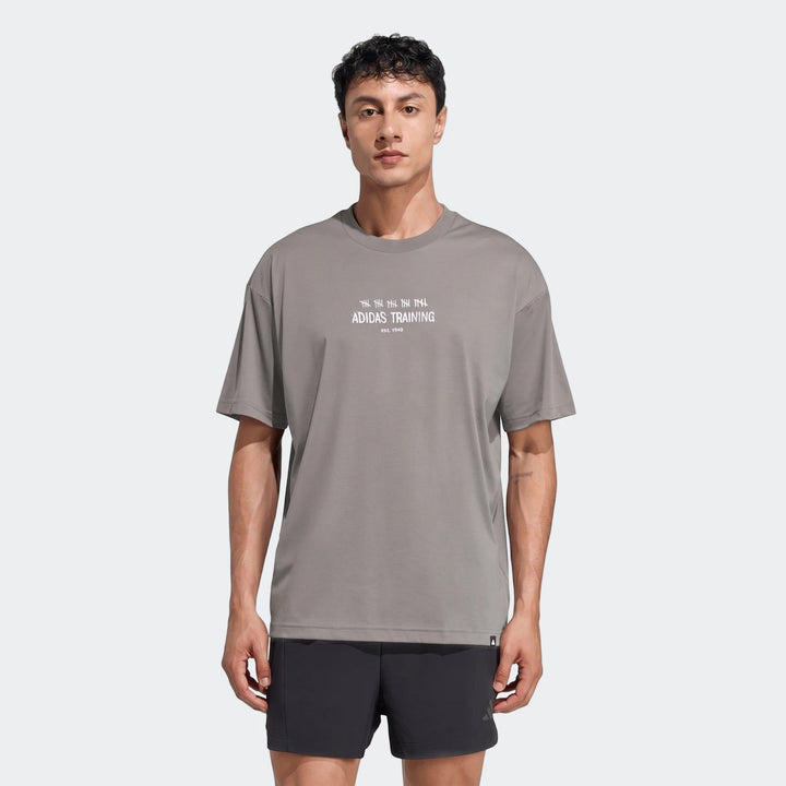Men's Adidas Primelift Graphic T-Shirt in grey, featuring a crew neck and short sleeves, worn by a model.