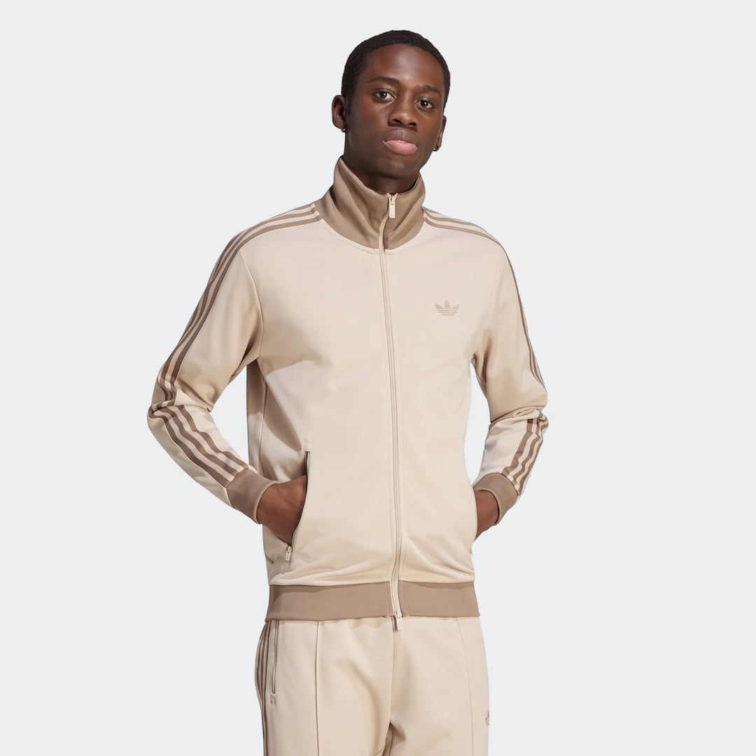 Men's beige Adidas Classic Track Top with matching track pants, featuring three brown stripes and a full zipper, worn by a