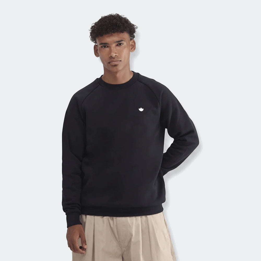 Men's black Essentials Crew Sweatshirt worn by a model in a studio, featuring a small white logo on the chest.