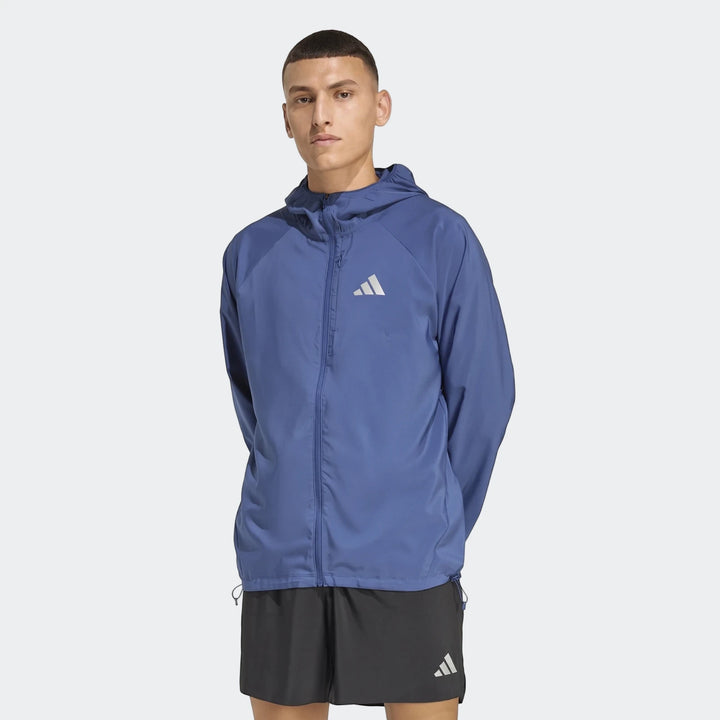 Men's blue Adidas Run Essentials hooded jacket and black shorts, shown on a model, full frontal view.