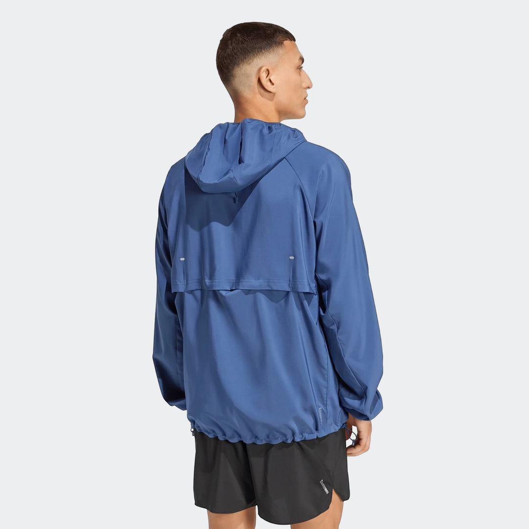 Men's blue hooded Run Essentials Jacket with black shorts, viewed from the back-right, showcasing the athletic design.