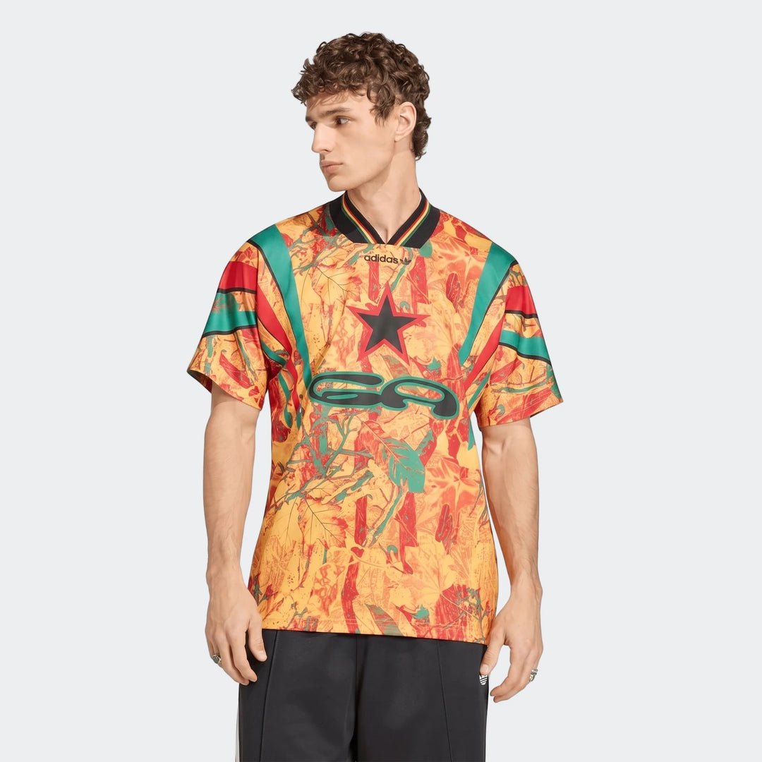 Men's colorful patterned short-sleeved Graphic Football Jersey in yellow, red, and green, worn by a male model.