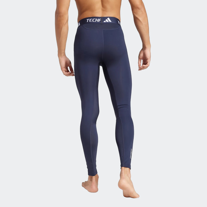 Men's dark blue football base layer tights, compression fit, shown from the back on a model.