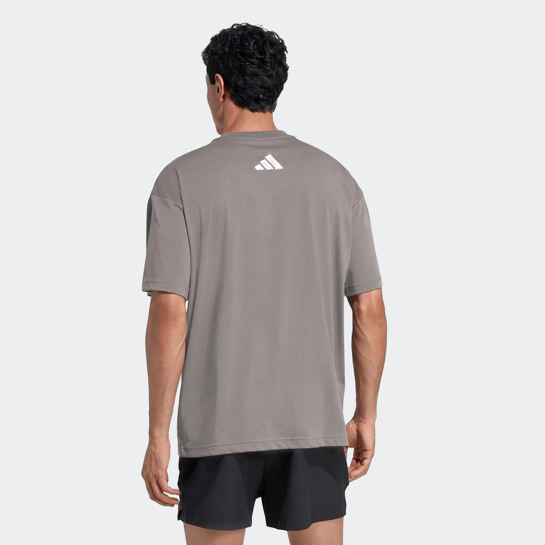 Men's grey Adidas Primelift Graphic T-Shirt, shown from the back, featuring a white logo on the upper back.