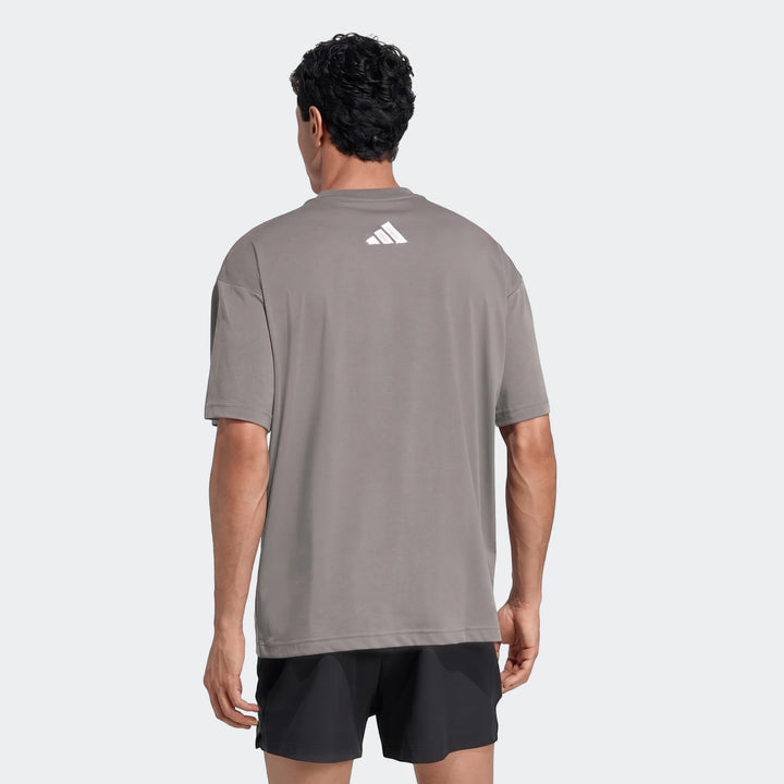 Men's grey Adidas Primelift Graphic T-Shirt, shown from the back, featuring a white logo on the upper back.