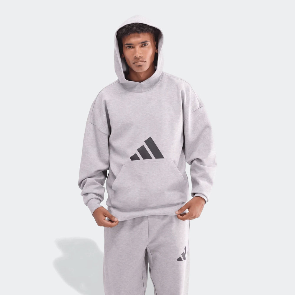 Men's light gray Adidas Future Icons 3-Bar Hoodie and matching sweatpants, front view, modeled on a male.