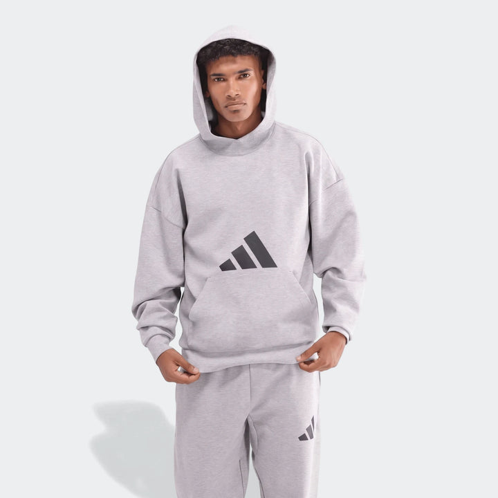 Men's light gray Adidas Future Icons 3-Bar Hoodie and matching sweatpants, front view, modeled on a male.