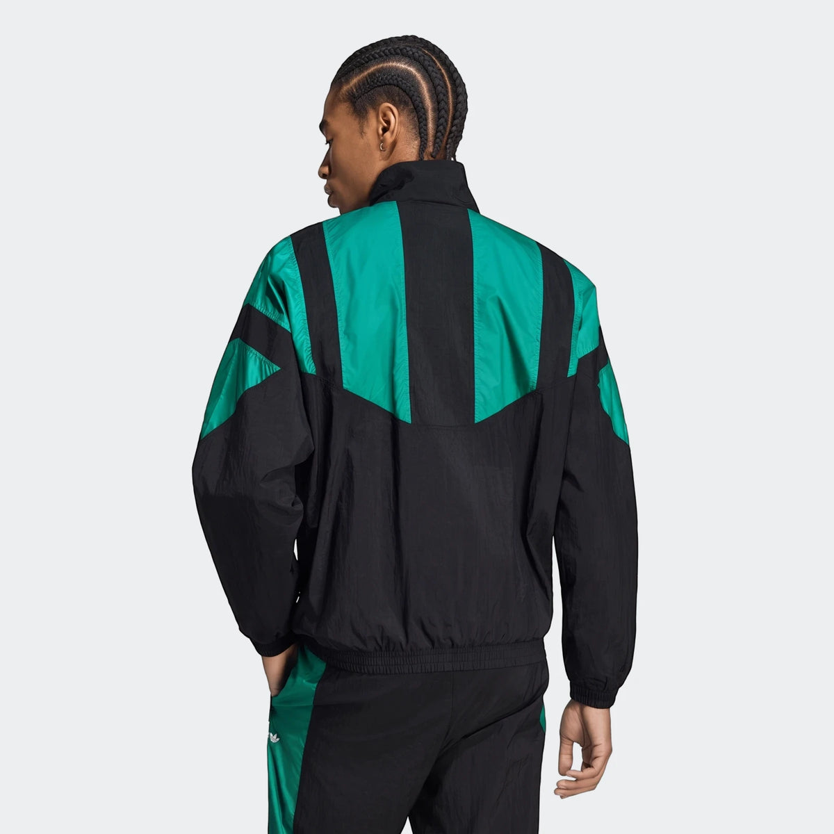 Men's Liverpool FC EQT Track Top in black and green, featuring a bold geometric panel design. Model shown from back.
