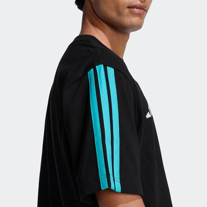 Men's black Mercedes-AMG Petronas Formula 1 Team DNA T-Shirt with turquoise stripes worn by a model.